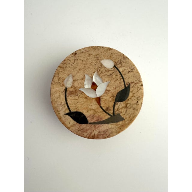 A beautifully handcrafted pietra dura round marble trinket box, showcasing the centuries-old decorative art form perfected...