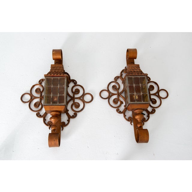 A one of a kind pair of custom made large fanciful lantern sconces. They are from a signifcant 1920s Cincinnati estate....