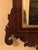 Elegant 19th Century Chippendale style mahogany mirror. The gilt swan neck pediment with rosette and urn motif, flanked by...