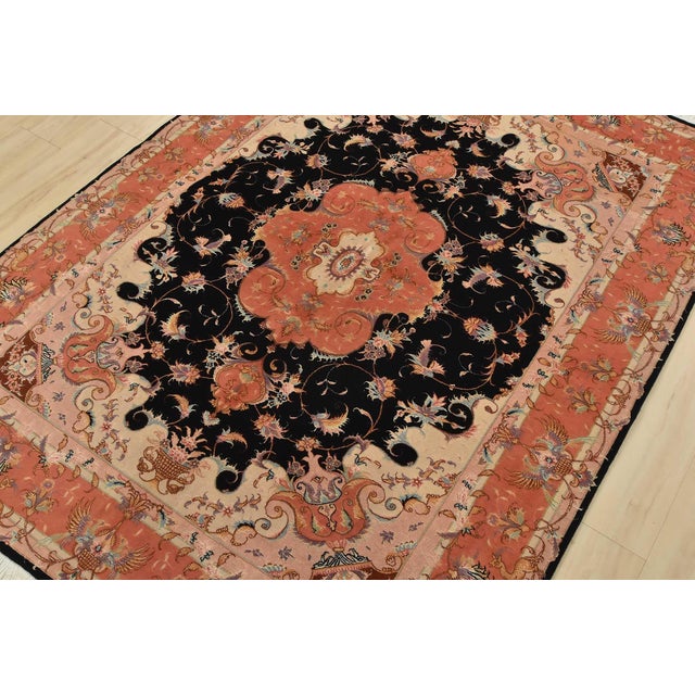An authentic vintage traditional Tabriz rug, hand-knotted with fine wool and silk highlights, using natural dyes. This...