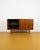 A 1960s Danish teak sideboard with two sliding doors and tapered legs in light wood—a combination typical of quality mid-...