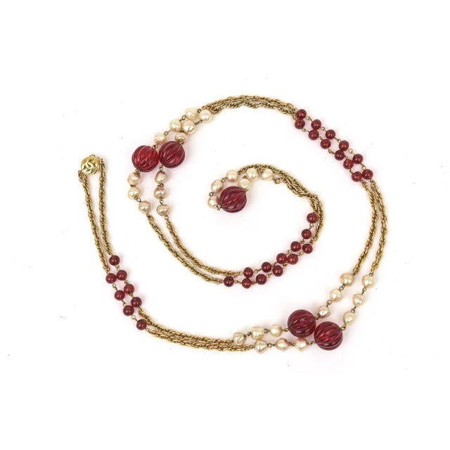 This fabulous long vintage Chanel sautoir necklace has red gripoix glass beads, faux pearls interspersed along the gold...