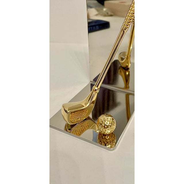 Set of brass and chrome golf bookends featuring brass club and ball with nice detail. Thin foam on bottom to prevent...