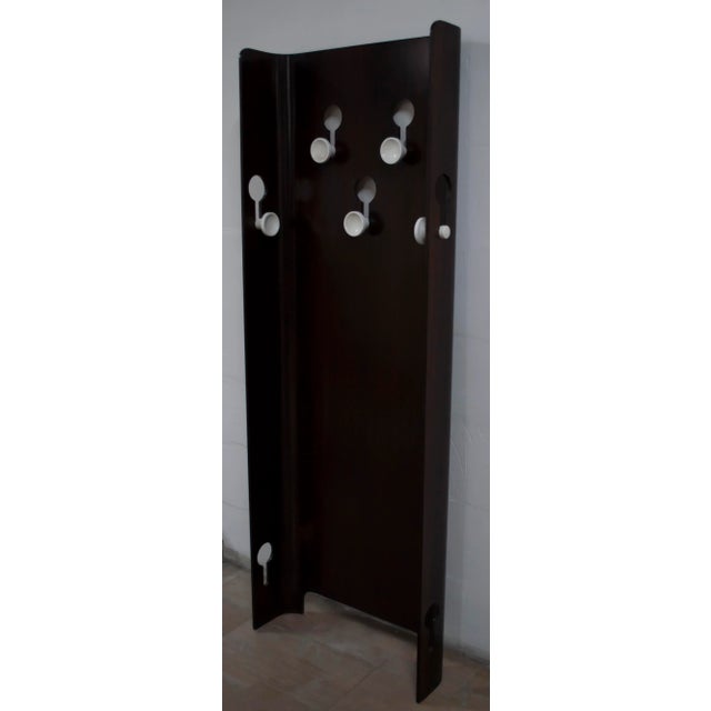 This 1960s coat rack from Fiarm is made of walnut and features bakelite knobs. This piece is attributed to the mentioned...