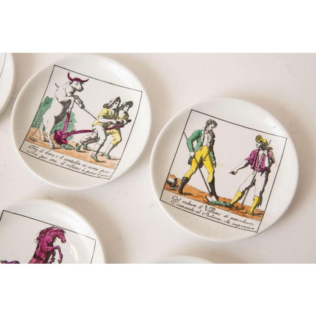 Piero Fornasetti Vintage Piero Fornasetti Porcelain Colored Opera Coasters Il Mondo Alla Rovescia Set of 8 Italian MCM For Sale - Image 4 of 12