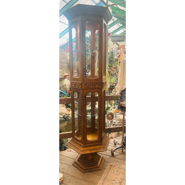 This mid-century vintage Hollywood Regency gold gilt double display tall tower cabinet is a glamorous, statement-making...