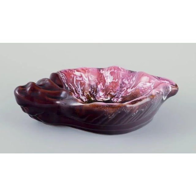 Vallauris, France, shell-shaped stoneware bowl with glaze in shades of pink and brown. Hand glazed. 1960s/70s. In...
