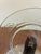 A set of seven vintage pressed glass plates featuring a delicate etched pattern along the rim. The clear glass design...