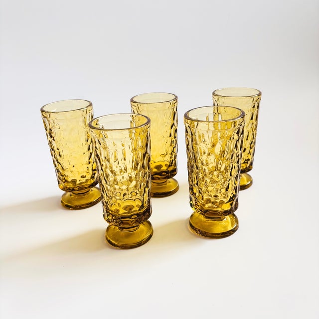 A set of 5 mid century footed water goblets. Made in the "Pebble Beach Yellow" pattern, produced between 1968 - 1973 by...