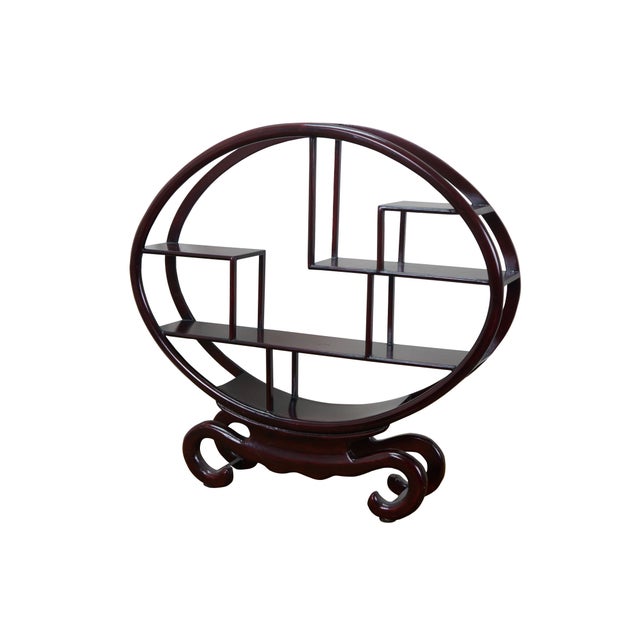 Pair of late 20th century Chinese mingei style wooden display stands / shelves. Scrolled bases supporting an oval frame...