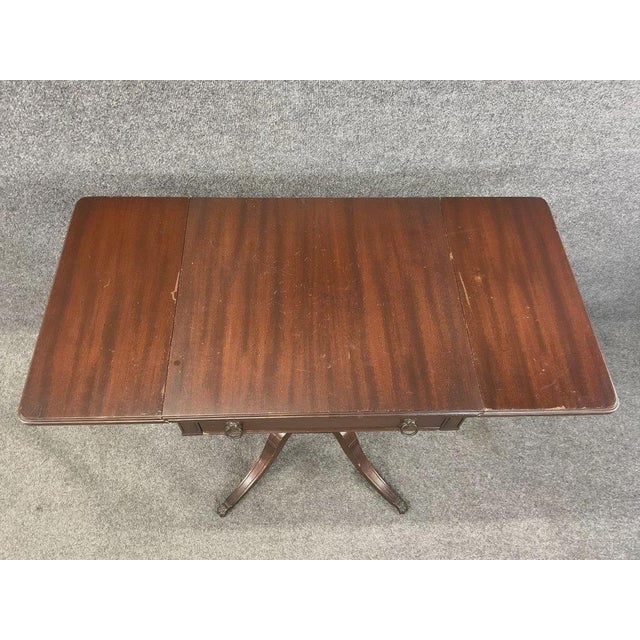 A beautifully crafted vintage drop leaf accent table by Imperial Furniture of Grand Rapids, Michigan, featuring elegant...