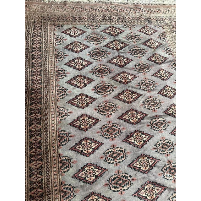 Vintage Pakistani rug with a tribal style Turkmen design and with a sky blue on field, pink, black and white on design,...