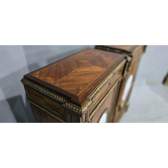 A wonderful tall pair of French Louis XVI kingwood cabinets with outstanding oval Sevres style porcelain plaques depicting...