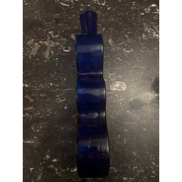 This gorgeous Vintage Blenko Glass is something to behold. Large 16", a true Cobalt Blue Hand Blown Wiggle Puzzle Vase is...