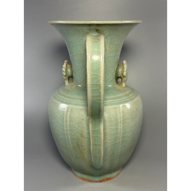 This is a premium antique Chinese Longquan celadon ewer with elegant spout and curved handle, decorated with delicate...