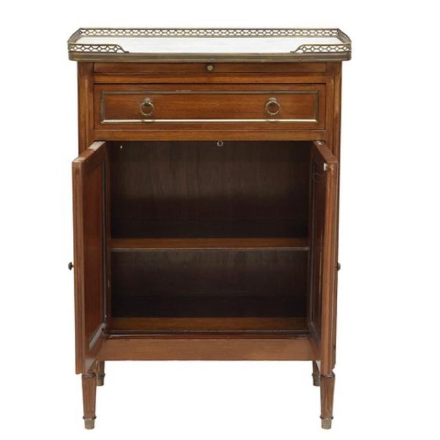 Very clean French Louis XVI style mahogany side cabinet, early 20th c., having inset marble top with pierced gilt-metal...