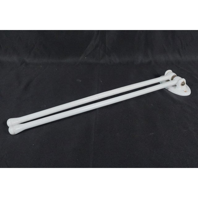 Mid Century style double arm wall mount towel rack. It is made of white enameled cast iron. Made in Belgium. The original...