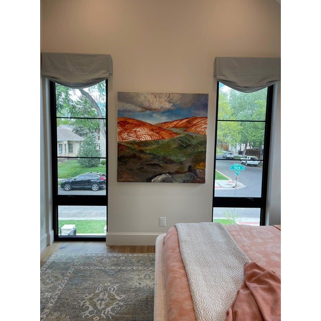 This oil on canvas artwork captures a sweeping landscape, characterized by rolling hills that blend warm earthy tones with...