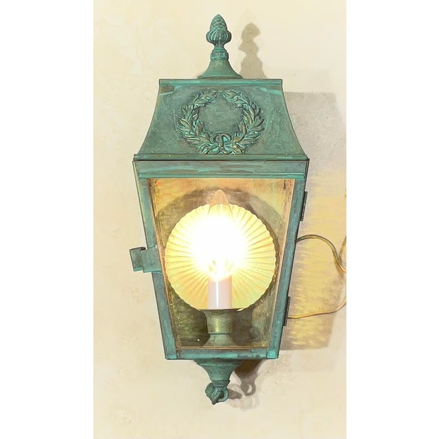 single exquisite Vintage Neoclassical Wall Lantern. Crafted from solid brass, this heavy-duty fixture features a timeless...