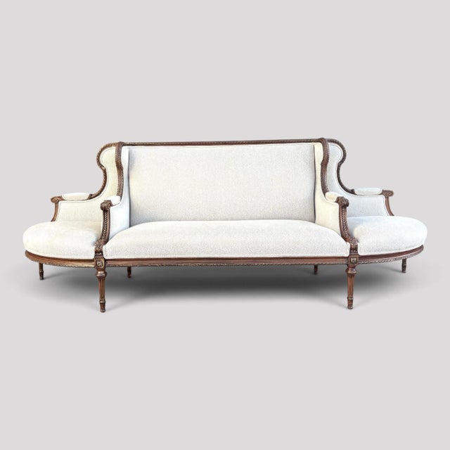 A wonderful and rare "Canapé à Confidante Sofa". A French Louis XVI style frame, fully carved with an acanthus leaf design...