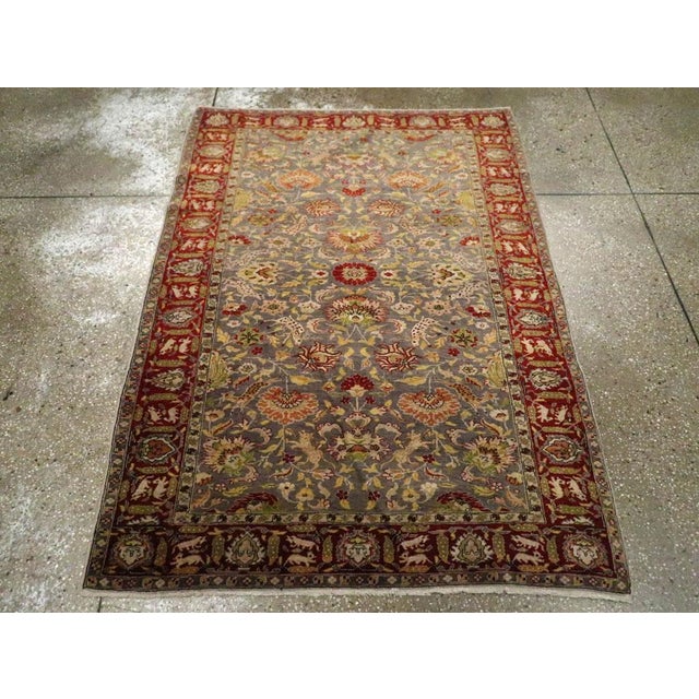 This Early 20th century Turkish Sivas rug, measuring 3' 11" x 5' 6", is a striking example of Ottoman-era weaving...