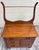 This is a gorgeous antique Victorian oak washstand featuring a shaped backsplash, tall towel rack, three drawers with...