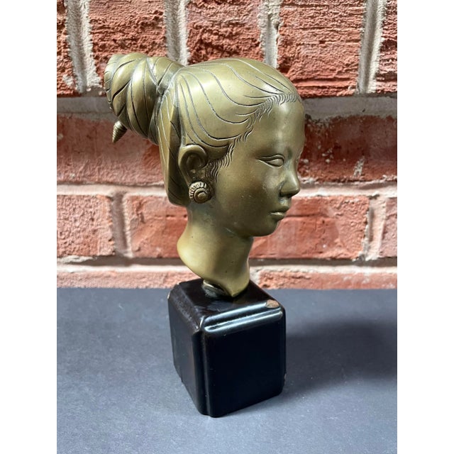 Stunning vintage brass bust depicting a beautiful young Laotian woman in the style of 20th century artist Nguyen Thanh Le...