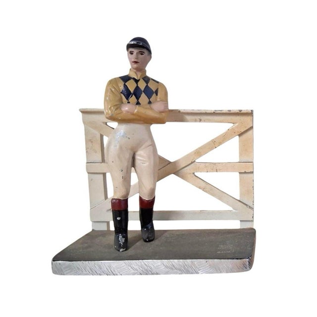 A charming pair of vintage equestrian/jockey bookends. Each features a cast metal bookend depicting a jockey leaning on a...