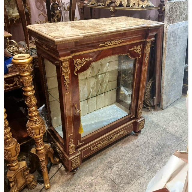 Showcase your most treasured collectibles in timeless French elegance with this exquisite French Louis XVI Display...