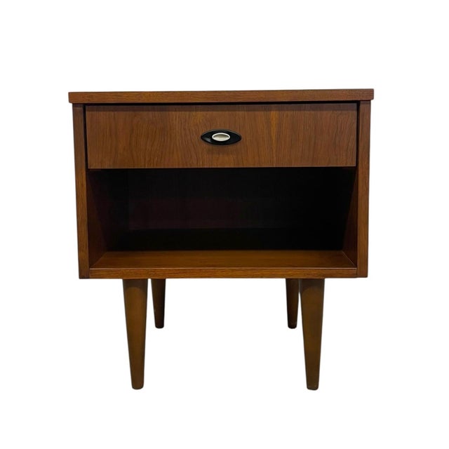This vintage mid century modern nightstand features a clean, streamlined form with a single upper drawer and an open lower...