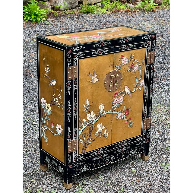 True vintage C1980s painted and carved Gold Leaf Lacquer Cabinet, featuring traditional Chinese themes of peonies and...