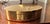 Oval brass box with lid and velvet interior. Very heavy weighs 1lb, 4 ounces. The lid features geometric logo composed of...