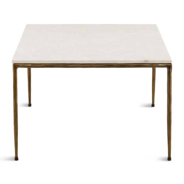 Modern and refined elegant coffee table featuring a beautiful white marble top supported by a slender hand-hammered iron...