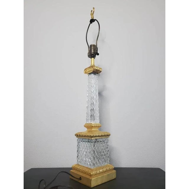 A Neoclassical style table lamp, single light, diamond-patterned molded glass standard and base, gilt metal mounts, laurel...