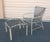 A set of 3 ottomans and 3 arm chairs by Brown Jordon. Brown webbing over putty color aluminum frames. Each labeled "Brown...