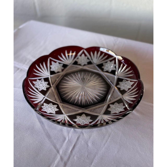 A striking example of early 20th-century Bohemian craftsmanship, this antique Art Deco plate features rich ruby red cut-...
