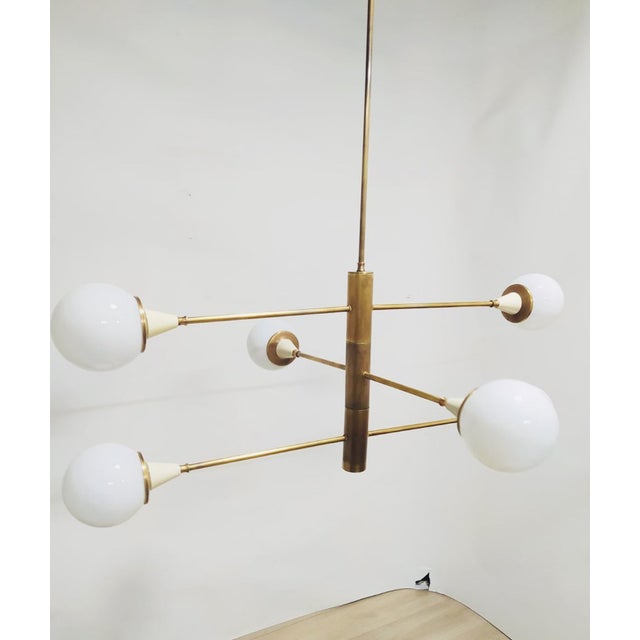 Mid-Century Brass Chandelier with Six Opal Spheres – Italy, 1960s Modular design with pairs of spheres that can be rotated...