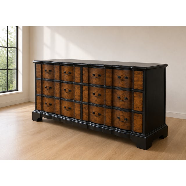 A striking Hollywood Regency triple dresser featuring twelve spacious drawers adorned in dramatic burl wood veneer framed...