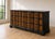 A striking Hollywood Regency triple dresser featuring twelve spacious drawers adorned in dramatic burl wood veneer framed...