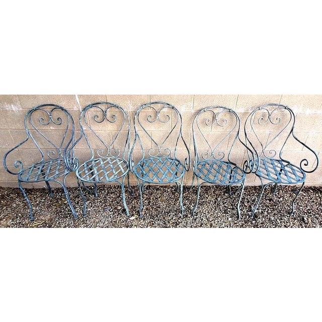 Rare set of 5 vintage/antique French wrought iron garden chairs with great patina. Each chair has a different degree of...