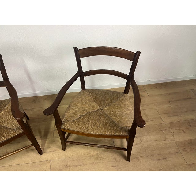 Pair of armchairs with a wooden frame and straw seat, handcrafted in Tuscany from the 1940s. The armchairs have been...