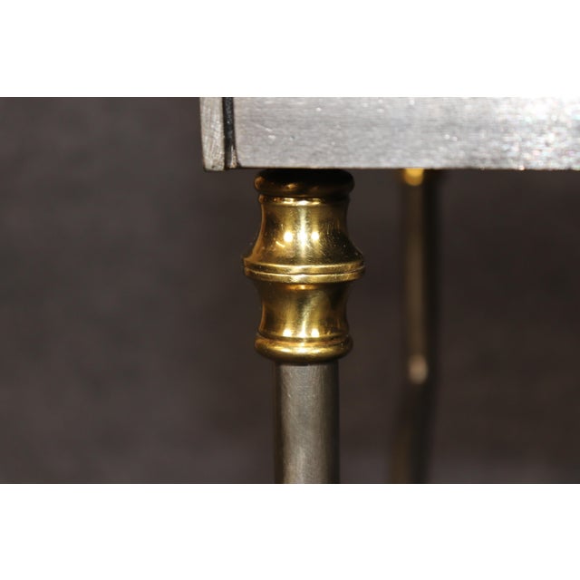 A striking and sophisticated John Vesey-attributed neoclassical desk or console table, combining a sleek metal framework...