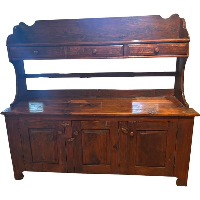 This hand chiseled pine bucket bench features three drawers and three doors. All drawers, doors and shelves are original...