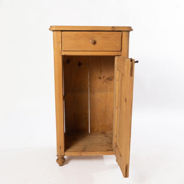 A beautiful antique scrubbed pine bedside cupboard with simple hand painted flowers, reminiscent of the aesthetic movement.