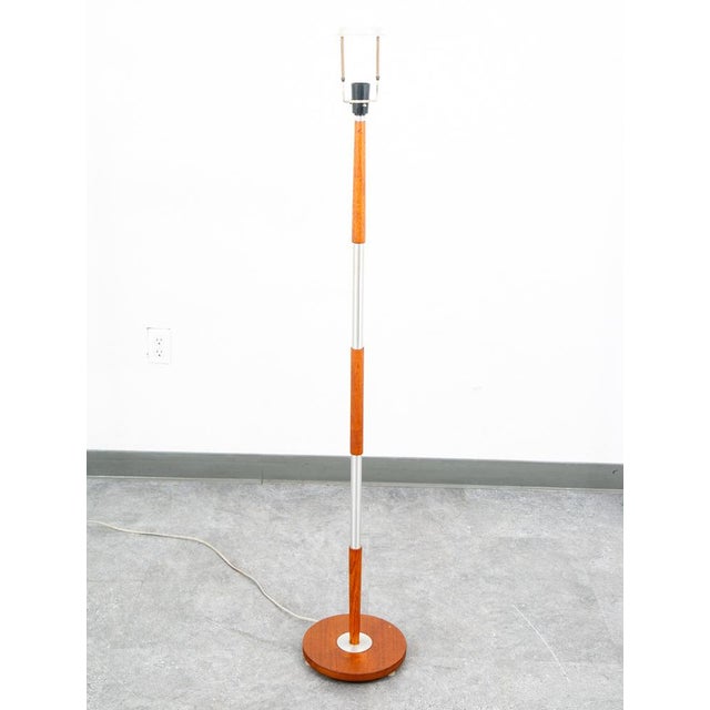 A mid century modern Danish designed teak and metal floor lamp. Lamp is tested and works well. This lamp is from Denmark...
