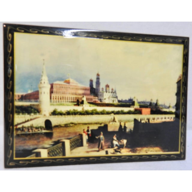 The Kremlin including the buildings with onion domes, are in the background of the waterfront scene on this Russian black...