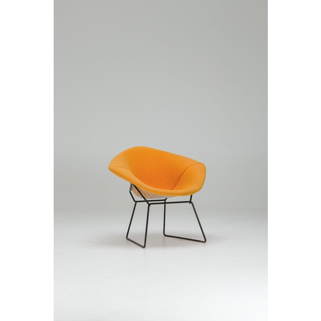 Part of Bertoia’s 1952 wire collection for Knoll. The shell is formed from bent and welded steel rods, creating a...