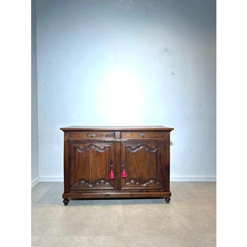 Beautiful antique sideboard in solid oak with warm patina and elegant carved panel details. This classic buffet has 2 top...