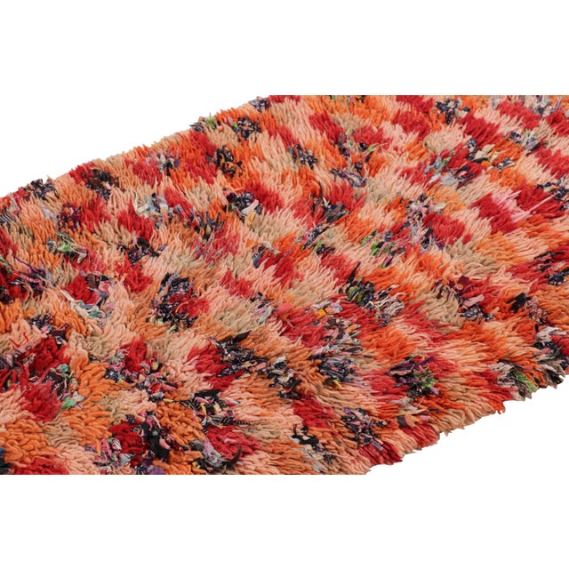 Hand-knotted in wool and originating from Morocco circa 1950-1960, this 3x6 vintage Moroccan rug is an extremely rare...