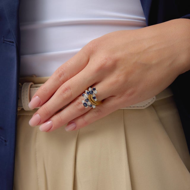 This striking vintage cocktail ring showcases a brilliant arrangement of 11 round brilliant cut diamonds totaling...
